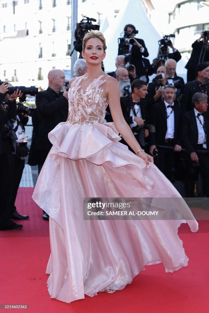 Sandra Ackerl attended “Dossier 137” red carpet at the 78th annual Cannes Film Festival in a salmon pink Gaby Charbachy gown.